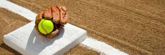 glove and softball on first base