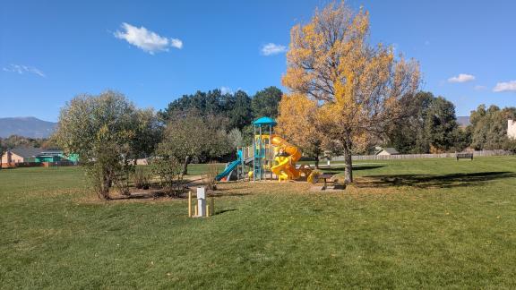 An "after" photo of the playground at Woodland Hills park, with the new playground equipment installed.
