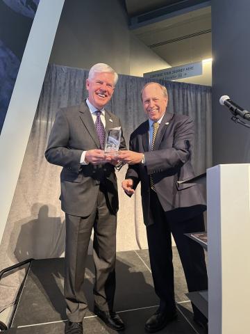 Mayor Suthers presents a Spirit of the Springs award to Doug Price, Visit Colorado Springs president and CEO