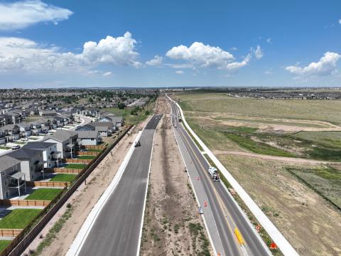 A view of Marksheffel Rd. looking north near N. Carefree Cir. The road is freshly paved in some parts, and still being constructed in others.