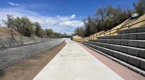 View of the freshly paved rock island trail with the new retaining wall installed.