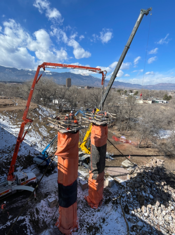 An aerial view of workers atop the newly installed westbound bridge columns