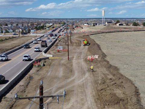 View of Marksheffel looking north at Huber. Cars are driving down Marksheffel while work is being done in parallel on the right-hand side.