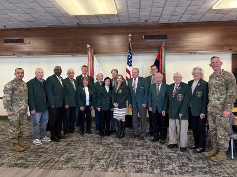 Jessie Kimber at the Fort Carson Good Neighbor induction ceremony, with previous inductees and enlisted from Fort Carson.