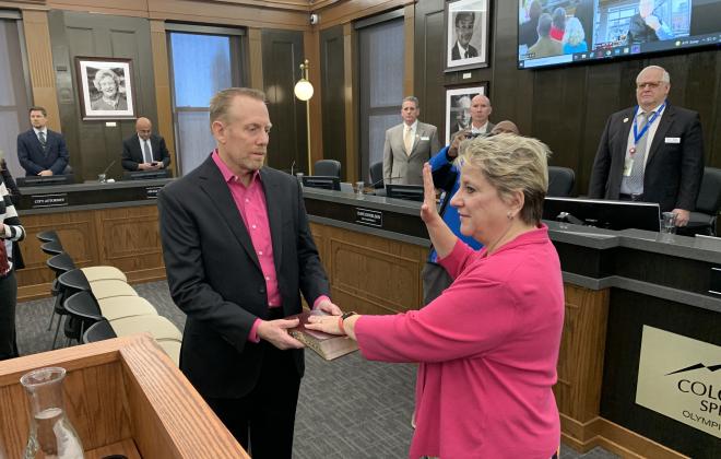 Stephannie Fortune being sworn into City Council. Accompanied by her husband, Kent Fortune.