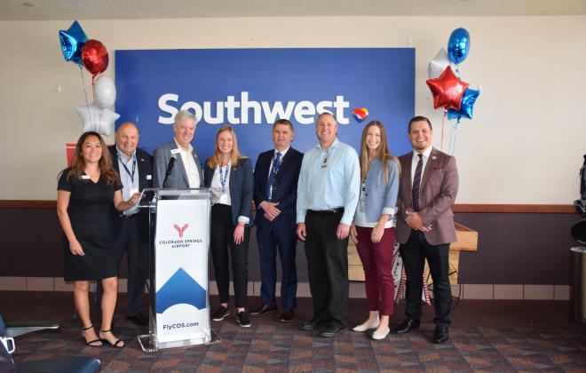 Community leaders gather at the colorado springs airport celebrating the inaugural colorado springs to baltimore flight