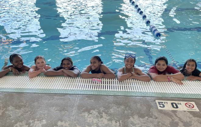 Camp attendees take a photo at the pool together