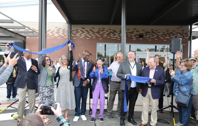 Mayor Yemi and other important people who were involved in the Senior Center renovation celebrating after the ribbon was cut.