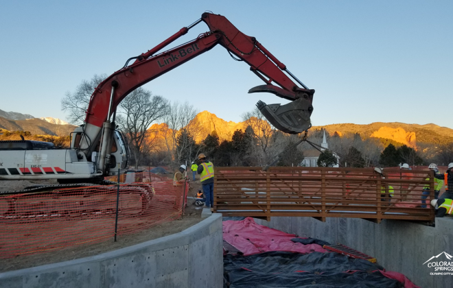 new pedestrian bridge across creek. Creek banks lined with concrete