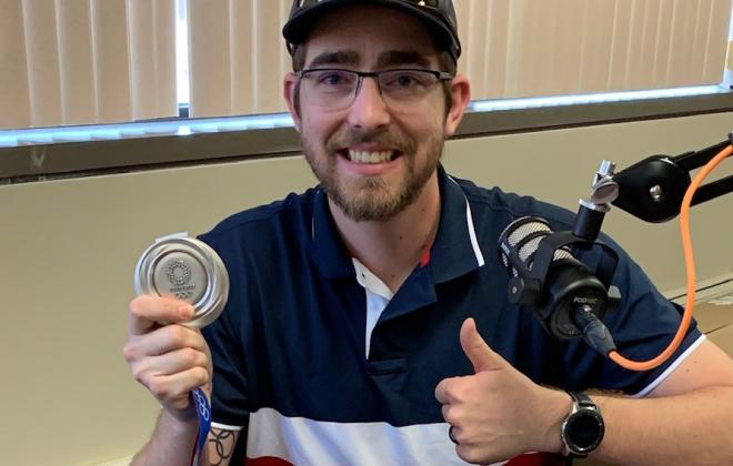 Lucas Kozeniesky showing off his Olympic medal